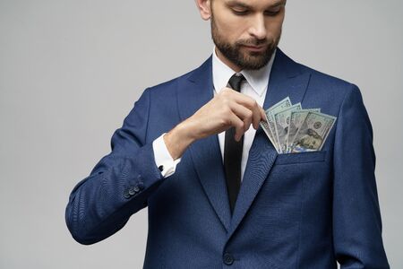 young handsome businessman holding US dollar bills