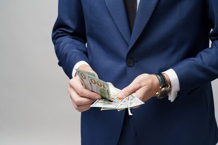 young handsome businessman holding US dollar bills