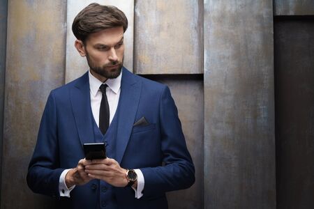 indoor photo of young handsome stylish businessman wearing suit