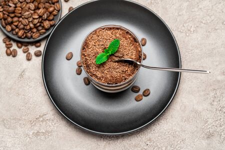 Classic tiramisu dessert in a glass cup on concrete backgroundの写真素材