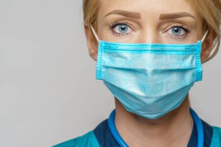medical doctor nurse woman with stethoscope wearing protective maskの写真素材