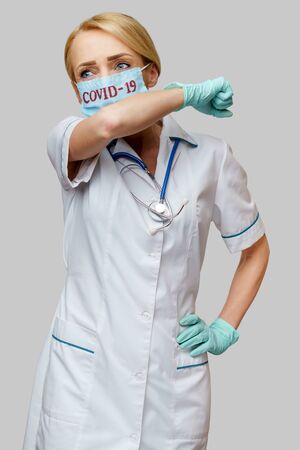 medical doctor nurse woman wearing protective mask and rubber or latex gloves - coughの写真素材