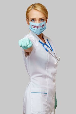 medical doctor nurse woman with stethoscope wearing protective maskの写真素材