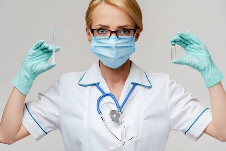 health medical worker woman holding vaccine and syringeの写真素材