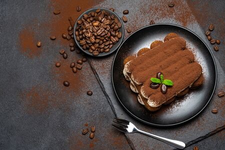 Classic tiramisu dessert on ceramic plate on concrete backgroundの写真素材