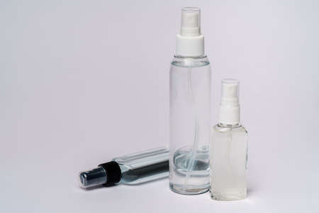 group of hand sanitizer spray or liquid soap bottles over light grey background.の写真素材