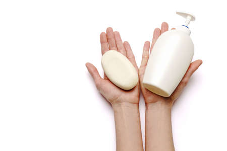 Female hands holding soap and hand sanitizer spray dispenser isolated on white background
