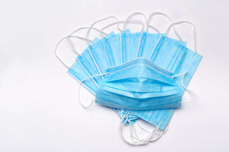 coronavirus COVID-19 pandemic concept - stack of antiviral surgical protective medical mask for...