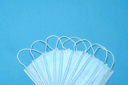 Disposable blue medical face mask on blue background