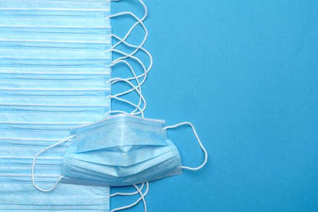 Disposable blue medical face mask on blue background