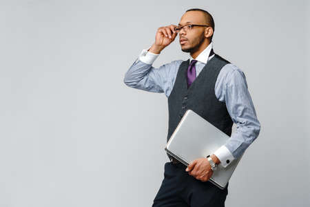 professional african-american business man holding laptop computer
