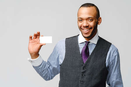 Afro-American businessman holding a white blank business card