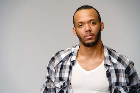 african-american young man wearing casual shirt over light grey backgroundの写真素材