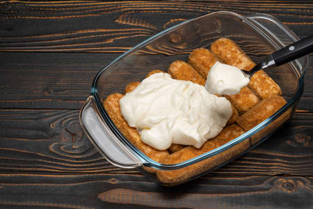 tiramisu dessert cooking - Traditional Italian Savoiardi ladyfingers Biscuits and cream in glass...