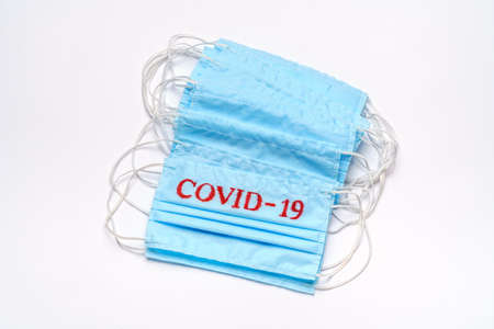 coronavirus COVID-19 pandemic concept - stack of antiviral surgical protective medical mask for...
