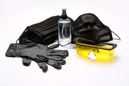 Safety equipment to fight to Coronavirus COVID-19 virus outbreak - Safety mask, hand sanitizer, latex gloves and protective glasses or gogglesの写真素材