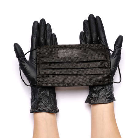 Human hand in protective glove holding face protective masks isolated on white background