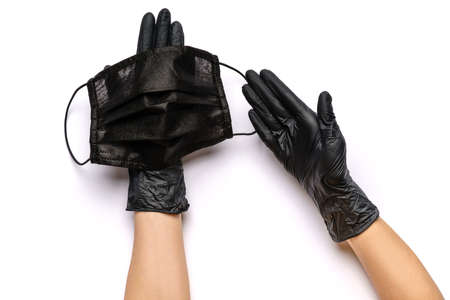 Human hand in protective glove holding face protective masks isolated on white background