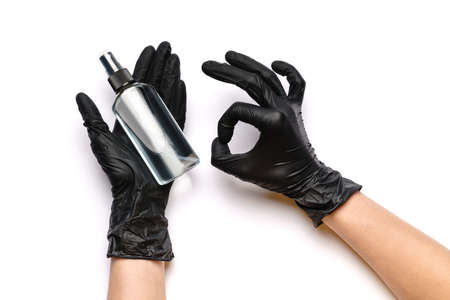 Human hand in protective glove holding alcohol hand sanitizer spray isolated on white background