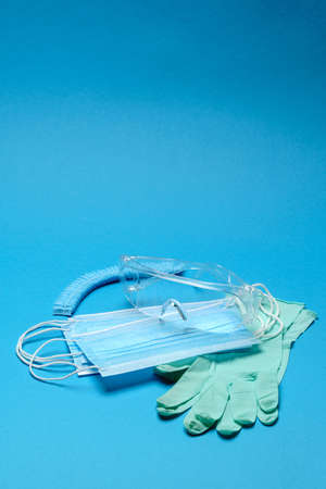 Safety equipment to fight to Coronavirus COVID-19 virus outbreak - Safety mask, hand sanitizer, latex gloves and protective glasses or gogglesの写真素材