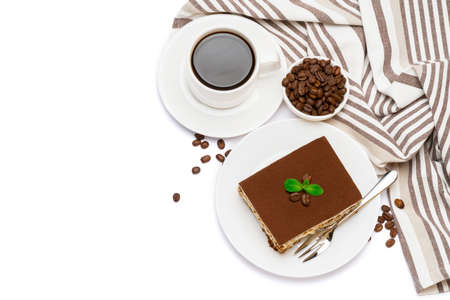 Traditional Italian Tiramisu dessert square portion on ceramic plate and cup of fresh espresso coffee isolated on whiteの写真素材