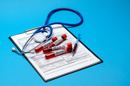 Clipboard with paper blank form with medical tools on blue background with cope spaceの写真素材