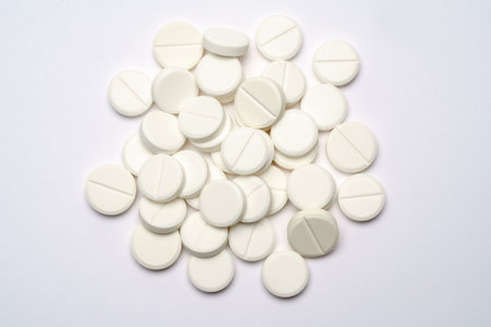 Heap of pills tablets over light grey background