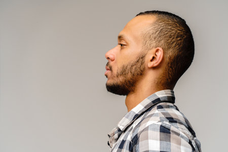 african-american young man wearing casual shirt over light grey backgroundの写真素材