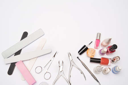 top view of manicure tools set for nail care over light background - brush, scissors, nail polish, file and tweezersの写真素材