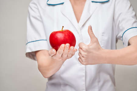 nutritionist doctor healthy lifestyle concept - holding organic red appleの写真素材