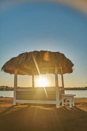 Cabana on a sandy beach on colourful evening at Red Seaの写真素材