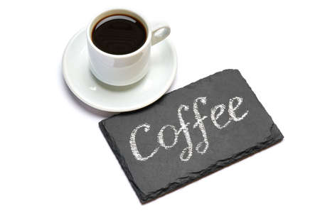 Coffee handwritten inscription sign on chalk board and cup of espresso on white background