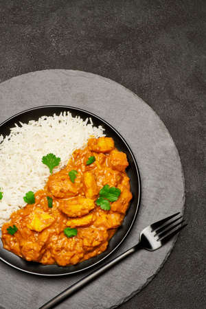 Plate of Traditional Chicken Curry and rice on stone serving boardの写真素材