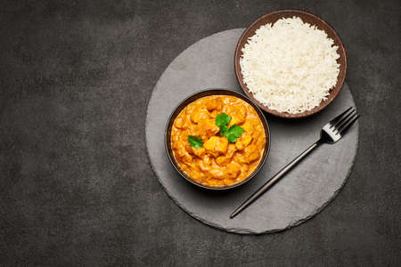 Plate of Traditional Chicken Curry and rice on stone serving boardの写真素材