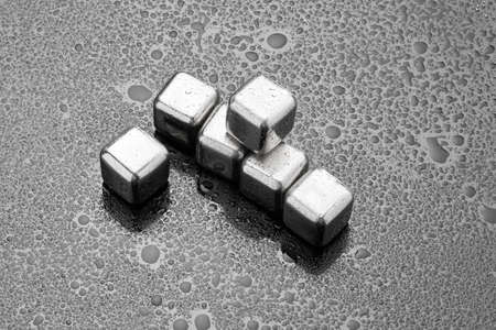 Steel cooling cubes for cocktail drink on glass backgroundの写真素材