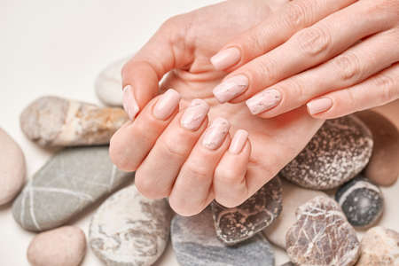 Woman hands with beautiful manicure on light background