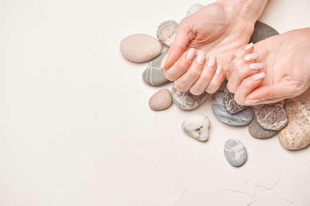 Woman hands with beautiful manicure on light backgroundの写真素材