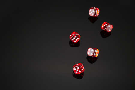 red and white craps or dices on reflective black backgroundの写真素材