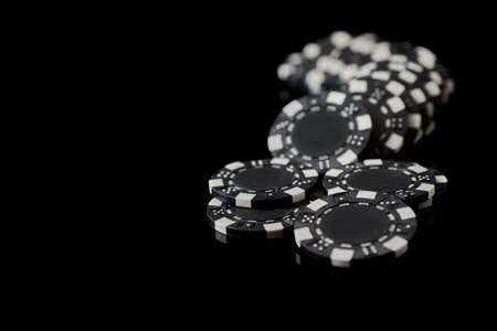 Stack of Casino gambling chips isolated on black reflective backgroundの写真素材