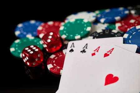 Casino chips, playing cards and dices on dark reflective backgroundの写真素材
