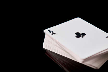 Full deck of playing cards with ace on top on dark reflective backgroundの写真素材
