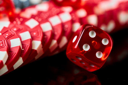 Red casino dice and chips isolated over black reflective backgroundの写真素材