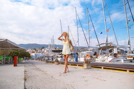 Beautiful girl tourist walking in the streets of Poros, Greece