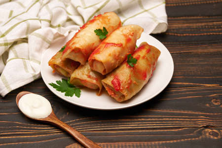 Portion of stuffed cabbage rolls on wooden tableの写真素材