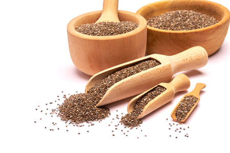 Wooden scoop of organic natural chia seeds close-up isolated on white backgroundの写真素材