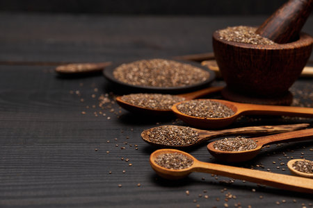 Bowl of organic natural chia seeds close-up on wooden background or tableの写真素材