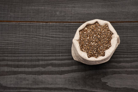 pouch full of Organic natural chia seeds on dark wooden background or tableの写真素材