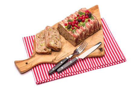 Traditional French terrine covered with bacon isolated on wooden cutting or serving boardの写真素材