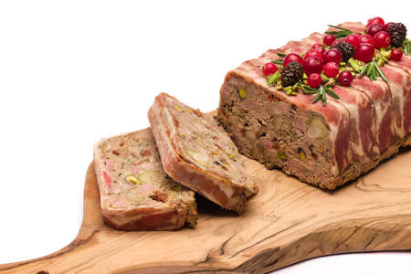Traditional French terrine covered with bacon isolated on wooden cutting or serving boardの写真素材