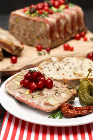 Traditional French terrine covered with bacon on dark wooden backgroundの写真素材